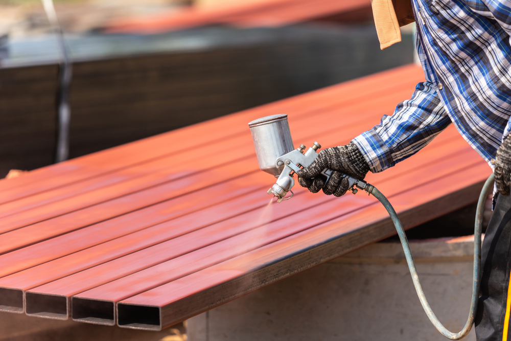 Construction,Worker,Spraying,Paint,To,Steel,Pipe,To,Prevent,The