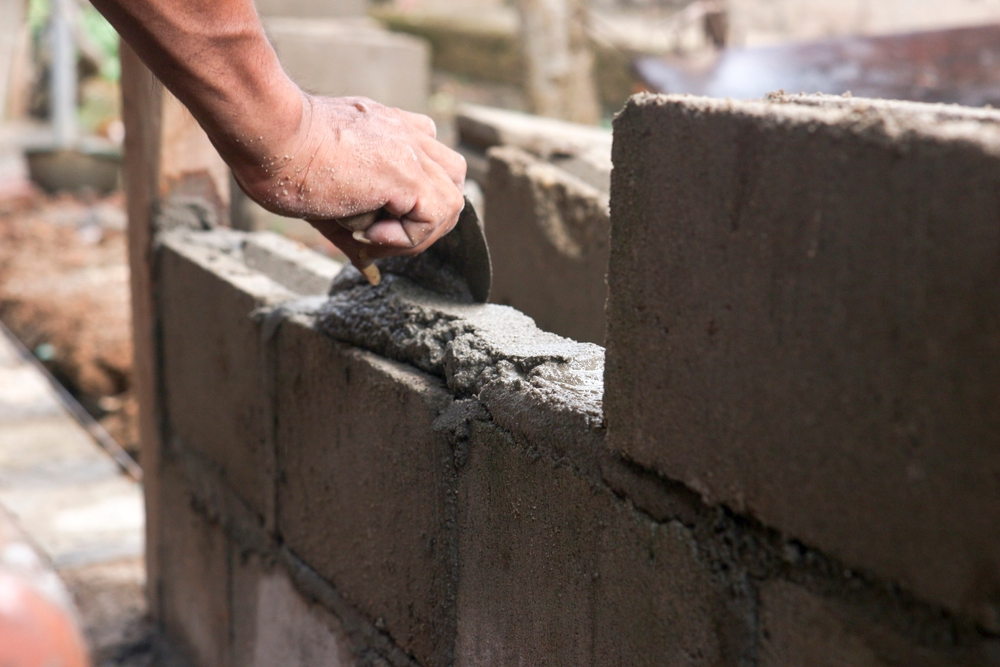 A,Bricklayer,Who,Is,Arranging,Bricks,For,Building,A,House